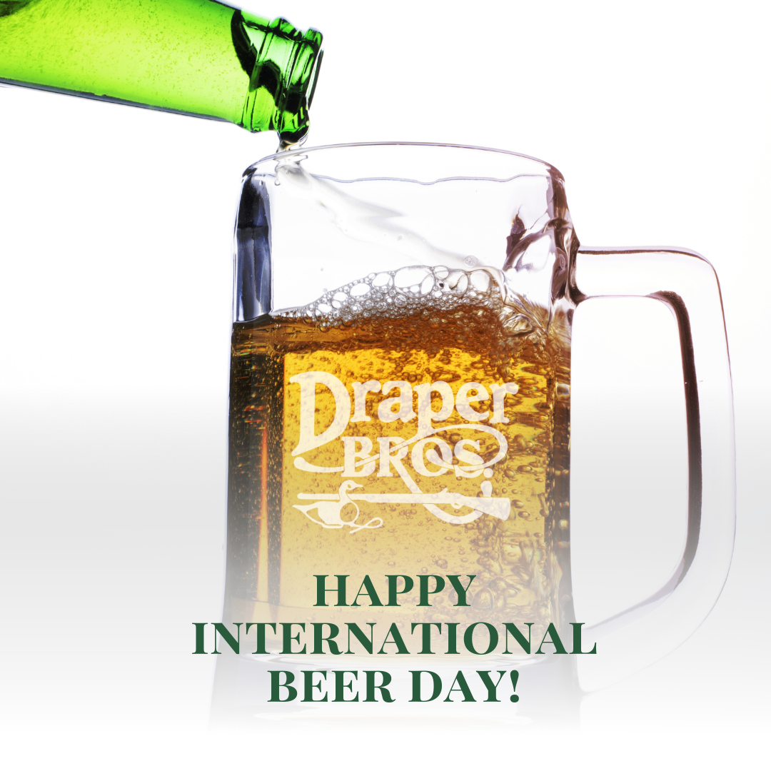 Background is beer from a green bottle being poured into a glass that has the Draper Bros. logo etched on it. Text overlay: Happy International Beer Day!